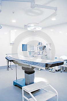 Empty operating room in a hospital. Surgical equipment with operating table. Medical device for emergency patient in