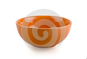 Empty orange bowl on white background