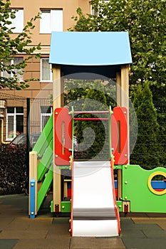 Empty outdoor children`s playground with slide in residential area