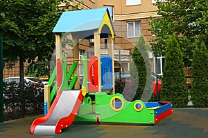 Empty outdoor children`s playground with slide in residential area