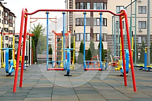 Empty outdoor children`s playground with swings in residential area
