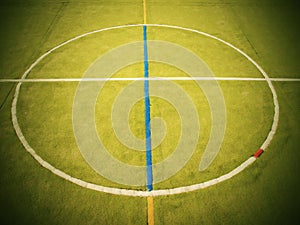 Empty outdoor handball playground, plastic light green surface on ground and white blue bounds lines.