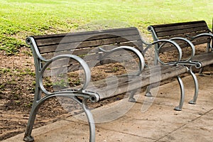 Empty outdoor park benches on sidewalk