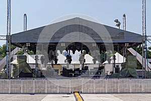 Empty outdoor real concert stage including robotic scenic lights setup during the day