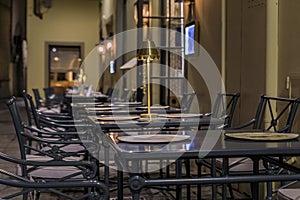 Empty outdoor tables at an Italian restaurant in Centro Storico, Florence, Italy