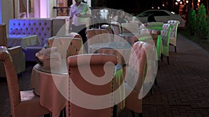 Empty outdoor terrace on a warm evening of a southern city. Media. Beautiful tables at the outdoors cafe or restaurant