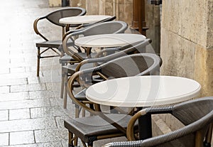 Empty outdoors bar, restaurant, cafe, elegant dining establishment area exterior simple detail, chairs and tables outside