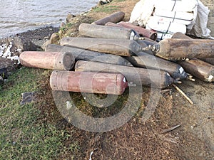 Empty oxygen cylinders piled up on the beach