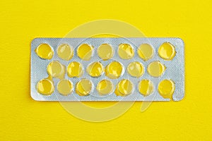 Empty package of tablets on yellow background