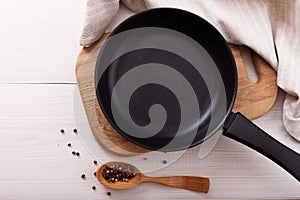 Empty pan on wooden deck table with tablecloth photo