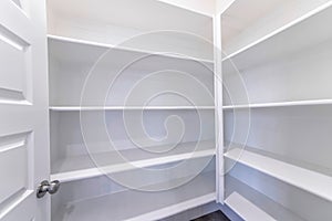 Empty pantry of house with built in shelves for storage and organization of food