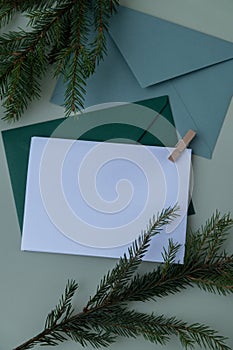 Empty paper letter envelope note Copy space Christmas mockup for lettering art drawing with fir branches on pastel green