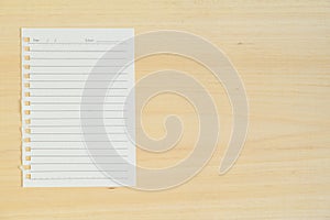 Empty paper note on wood background