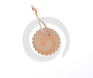 empty paper round brown tag on a rope, white background