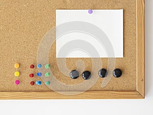 Empty paper sheet mockup for notes. Cork board background with colorful pins