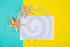 Empty paper sheet with two starfishes on colored backgrounds wit