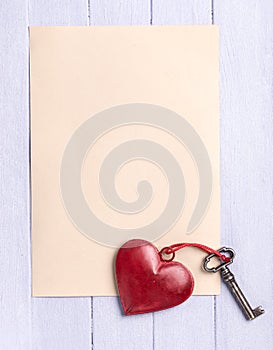 Empty paper sheet with a vintage heart and old key