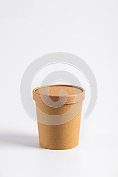 Empty paper soup cup on a white background. Brown food container for ice cream, noodles or other dishes. ecological product that