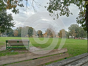 Empty park on autumn in a rainy day with overcast sky