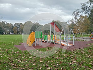 Empty park on autumn in a rainy day with overcast sky