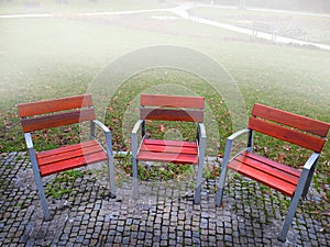 Empty park banches and seats in November.