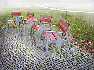 Empty park banches and seats in November.