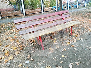 Empty park bench in autumn