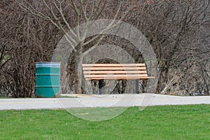 An empty park bench in a city park.