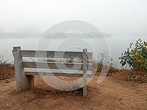 Empty park bench on the edge of a lake