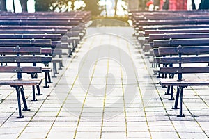 Empty park benches rows in front of an open air stage. Bulgaria, Bourgas, Sea Garden.