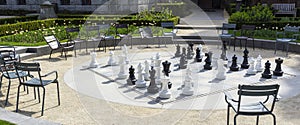 Empty park with big chess figures and empty chairs on background.Nobody playing in games.Banner.