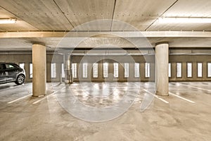 an empty parking garage with a car parked in it