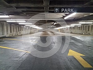 Empty parking garage with yellow arrow