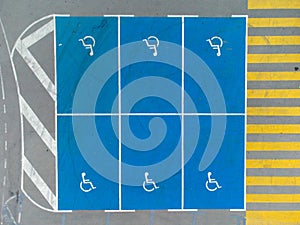 Empty parking lot with car spaces for people with disabilities, aerial view.