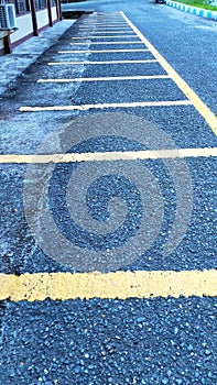 Empty parking space for motorbikes and bicycles with yellow lines