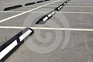 Empty parking space with white lines and stops