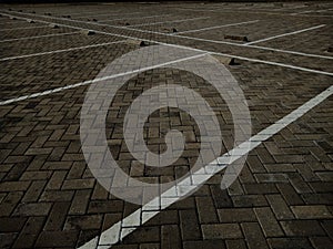 Empty parking spaces outdoor with brick tiles ground