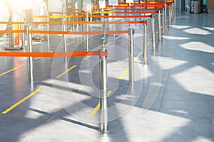 Empty paths bounded by a red ribbon to the check-in desks and baggage claim at the passenger airport terminal