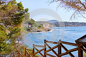 Empty pathway fenced with wooden railings lead to Benissa beach. Spain photo