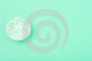 Empty patterned cupcake liner on textured background