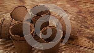 Empty peat pots for seedlings on a wooden background. Gardening