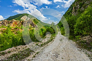 Empty rural road through mountain clifs photo