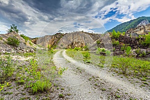 Empty rural road through rugged terrain photo