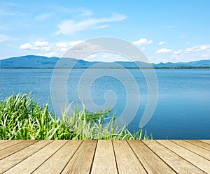 Empty perspective wood over lake and blue sky background, spring