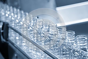 The empty PET bottles  on the conveyor belt for filling process in the drinking water factory