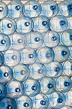 Empty PET bottles for drinking water stacked, vertical.