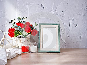 Empty photo frame candles artificial red rose on bike toy on wood table, cement texture background, gray color ,copy space for le