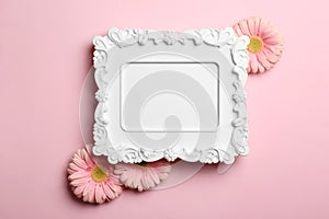 Empty photo frame and flowers on color background