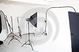 Empty photo studio background with photography lighting equipment