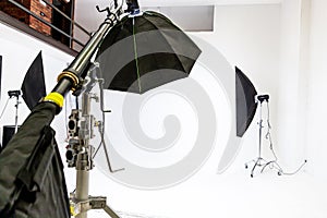 Empty photo studio with lighting equipment. Photographer workplace interior with professional tool set gear. Flash light